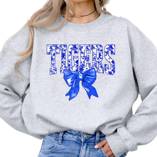 Tigers sweatshirt front view showing blue floral lettering and bow detail on white pullover