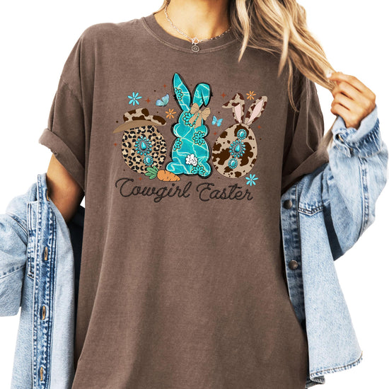 Women's espresso brown graphic tee with cowgirl Easter bunnies design featuring cow print hat and rope-style font