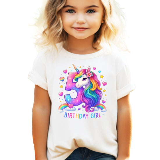Close-up of vibrant rainbow unicorn print with hearts and stars on pink birthday shirt