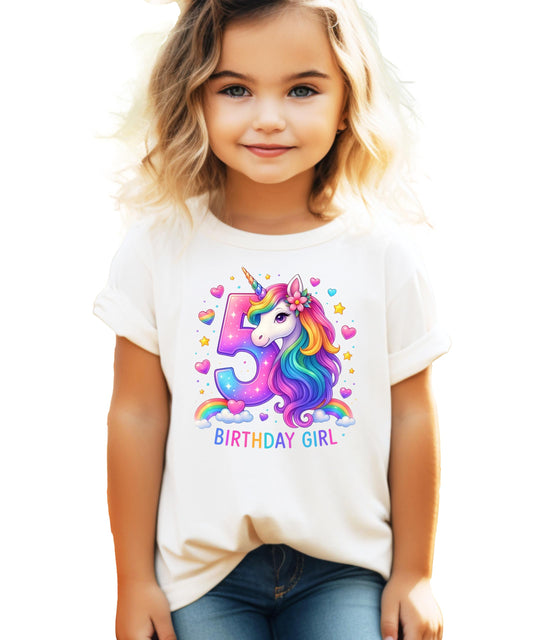 Close-up of vibrant rainbow unicorn print with hearts and stars on pink birthday shirt