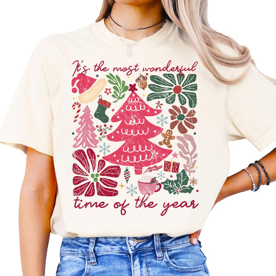 Close-up of holiday collage graphic print on ivory women's Christmas tee