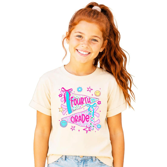 Young girl wearing fourth grade floral pennant shirt styled as a first day of school outfit