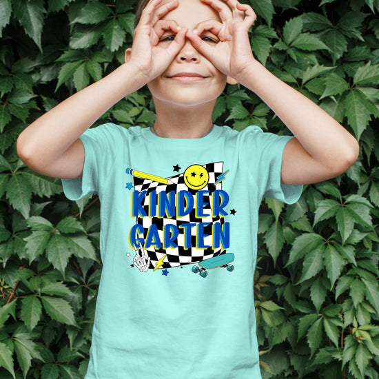 Flat lay of retro kindergarten skateboard t-shirt for boys, first day of school style