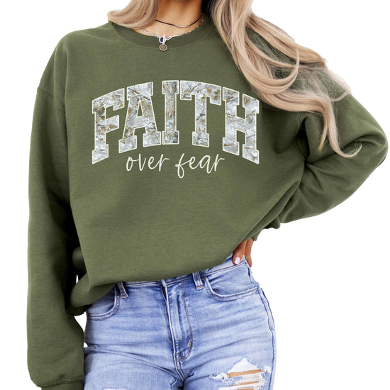 Flat lay of army green Faith Over Fear inspirational graphic pullover sweatshirt
