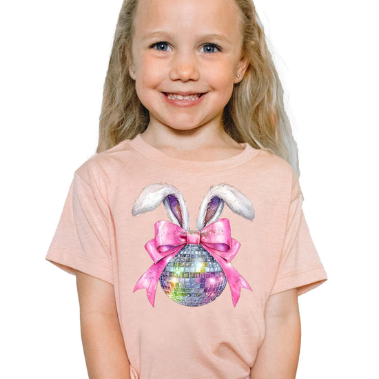 Youth girl modeling pink disco bunny Easter tee with coquette bow graphic print