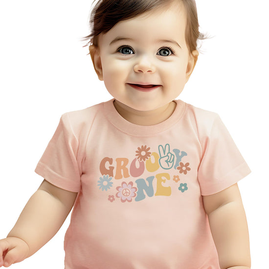 Detail shot of vibrant groovy daisy graphic on girls first birthday shirt