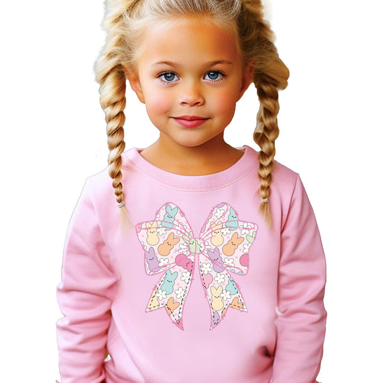Close-up of Easter bow and bunny graphic print on girls pastel sweatshirt