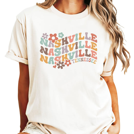 Kids and women's Nashville Tennessee colorful groovy graphic tee flat lay