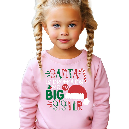 Youth girl modeling a festive Big Sister Santa Christmas sweatshirt in natural heather colorway