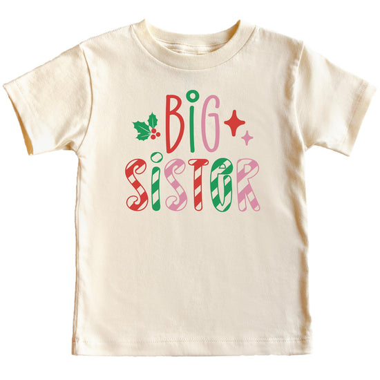 Girls wearing big sister candy cane Christmas graphic tee in natural fabric for holiday styling