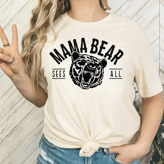 Mama Bear Sees All mothers day shirt gift idea shown on peach tee