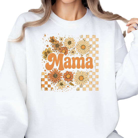 Flat lay of black women's fall sweatshirt with orange daisy and checkered mama graphic