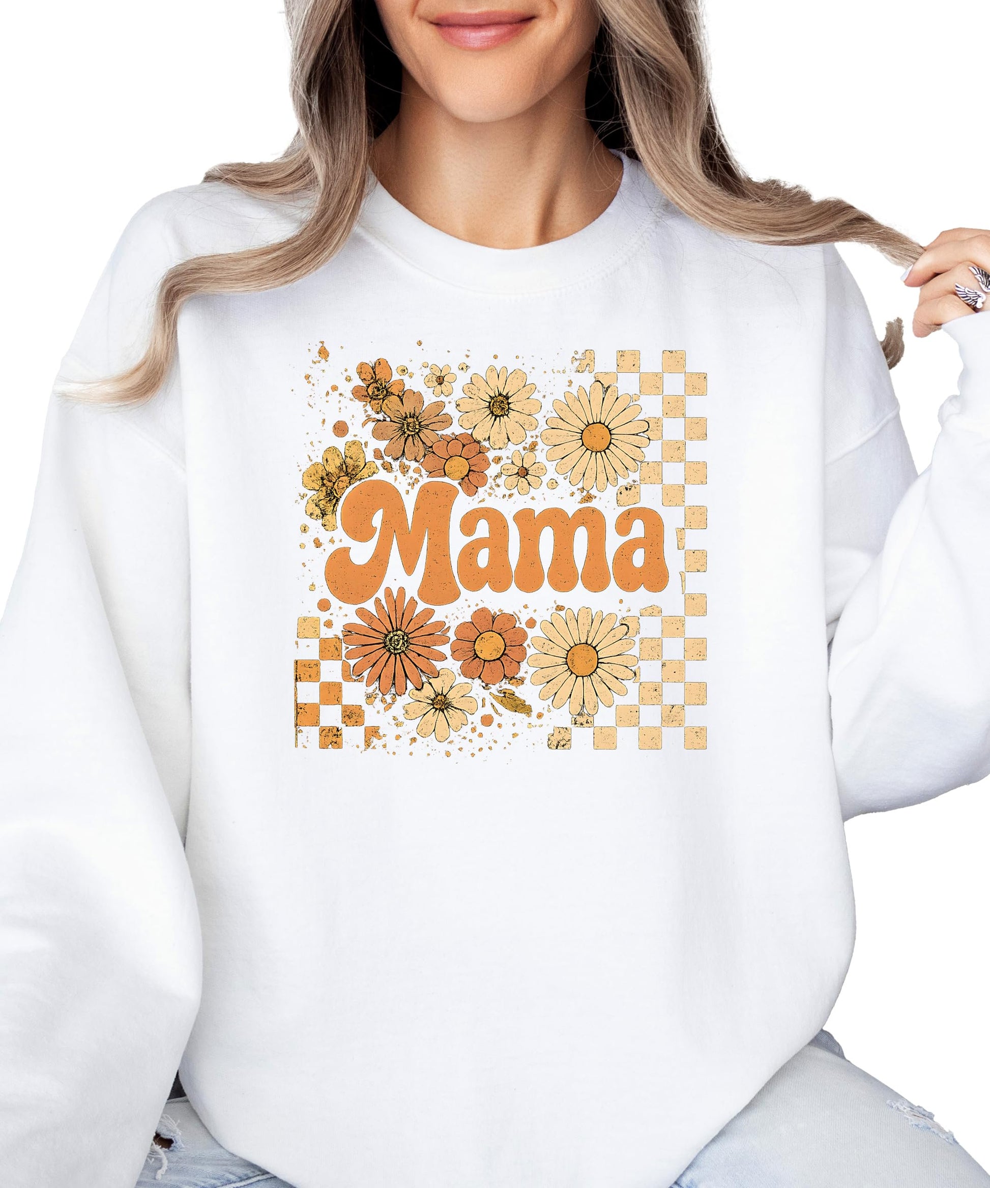 Flat lay of black women's fall sweatshirt with orange daisy and checkered mama graphic
