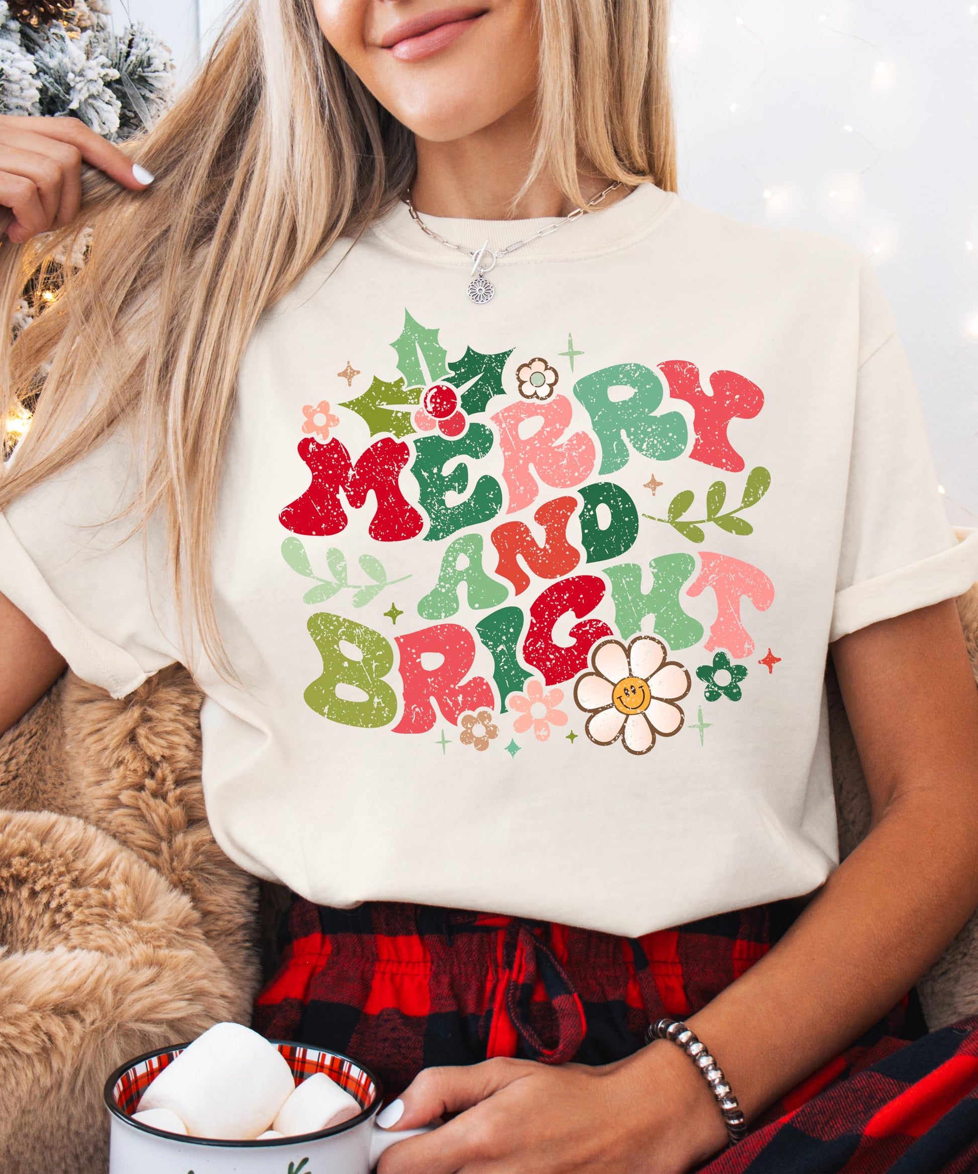 Flat lay of ivory Merry and Bright distressed Christmas shirt showing full graphic design