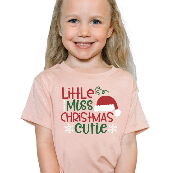 Little Miss Christmas Cutie kids tee in peach — perfect for family holiday photo outfits
