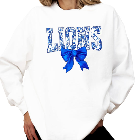Women's blue floral Lions graphic sweatshirt with coquette bow detail on black fabric