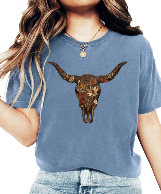 Close-up of longhorn skull graphic design with floral accents on seafoam western t-shirt