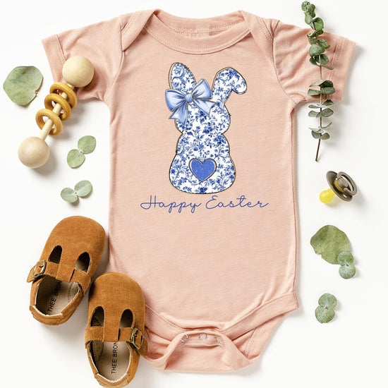 Side view of baby wearing blue floral chinoiserie Easter bodysuit with bow detail