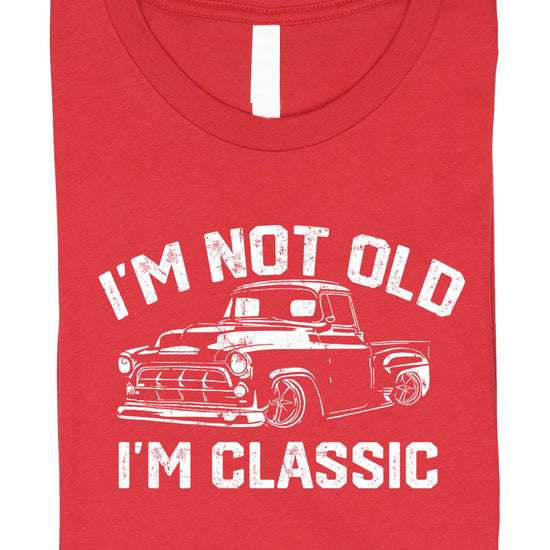 Men's black humor graphic tee flat lay showing full classic car design and slogan