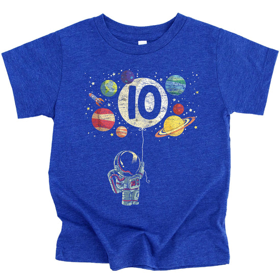 Young boy wearing Olive Loves Apple 10th birthday astronaut shirt in vintage royal