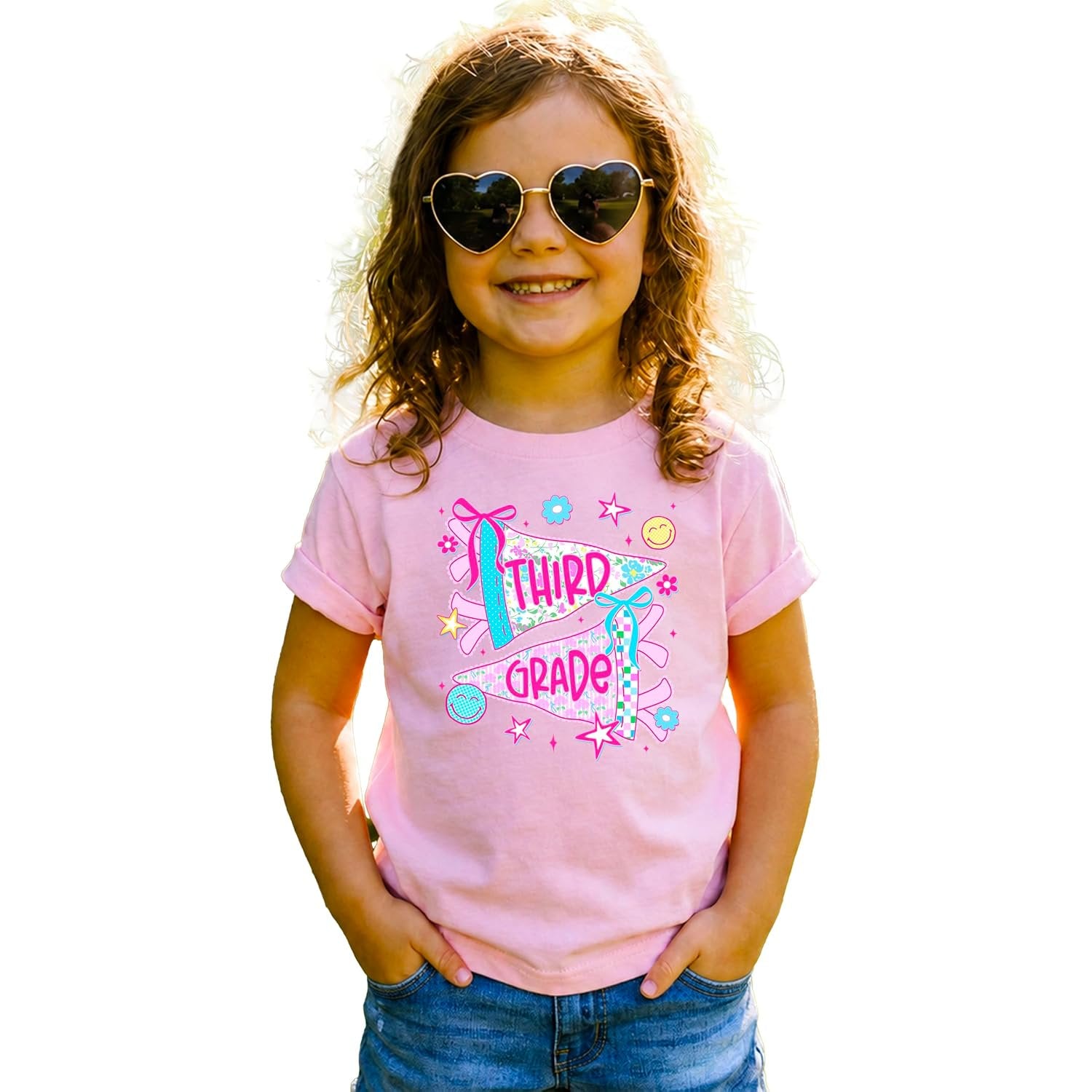 Girl wearing third grade floral pennant tee styled with jeans, perfect for first day of school outfit