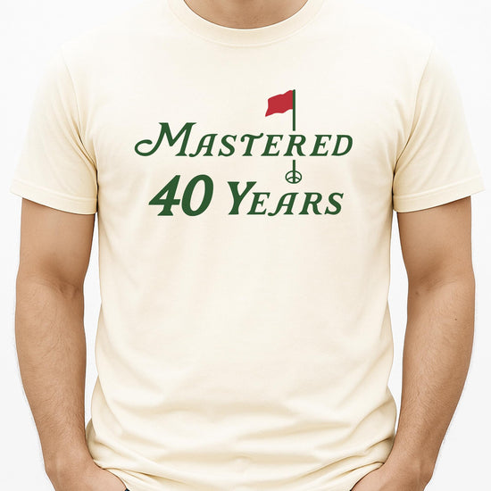 Close-up of Mastered 40 Years golf theme print on a vintage green unisex birthday t-shirt