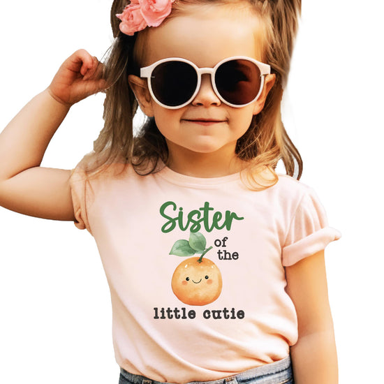 Close-up of One Little Cutie orange birthday graphic print on soft snap bodysuit