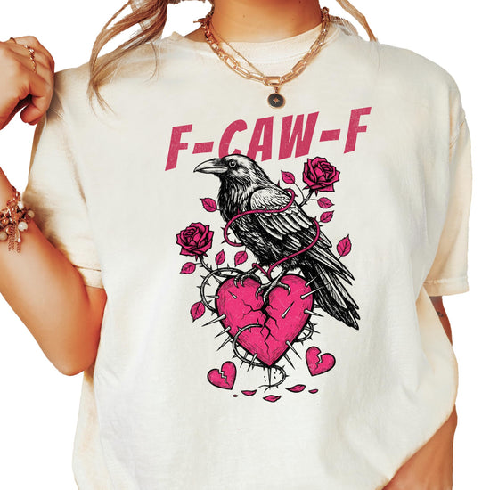Ivory women's graphic tee with a crow and broken heart design, funny anti-Valentine's Day shirt