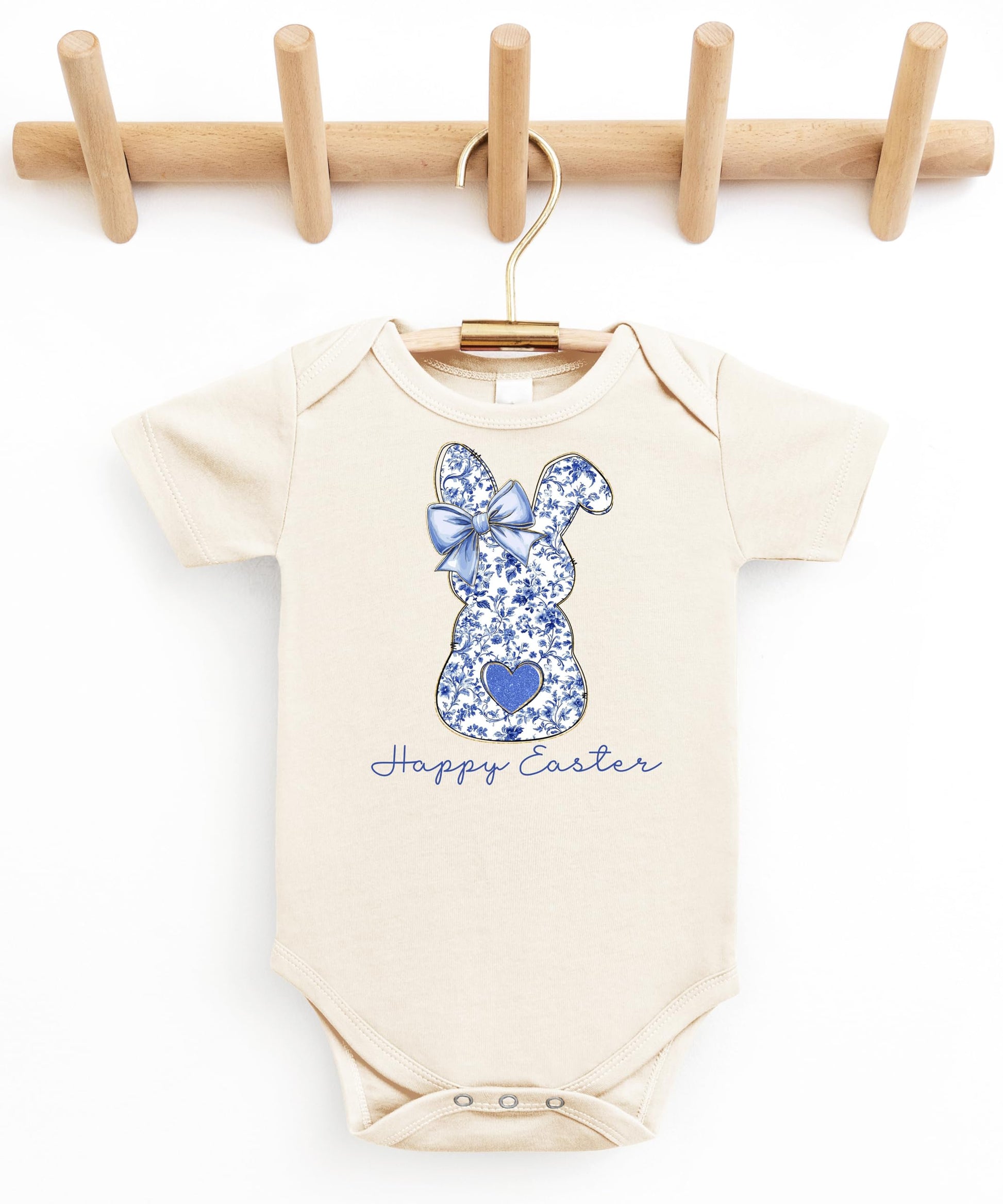 Detail shot of Happy Easter script and floral bunny silhouette on peach baby bodysuit