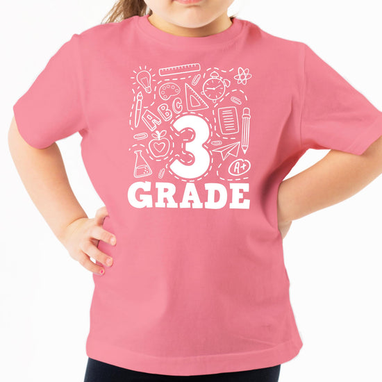Flat lay of youth mauve third grade raglan and tee back to school shirt set