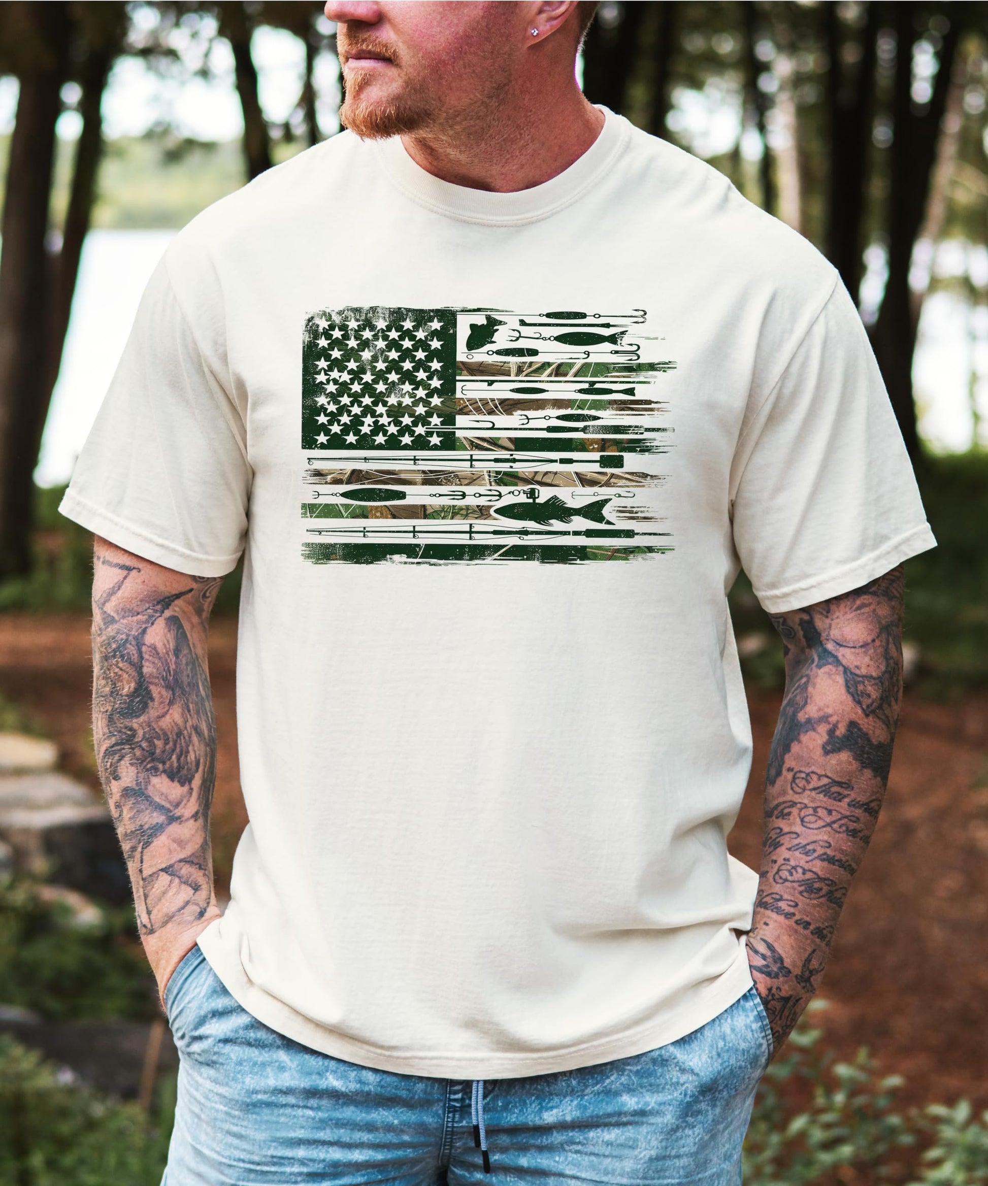 Close-up of American flag fishing pole and lure graphic print on ivory men's tee from Olive Loves Apple