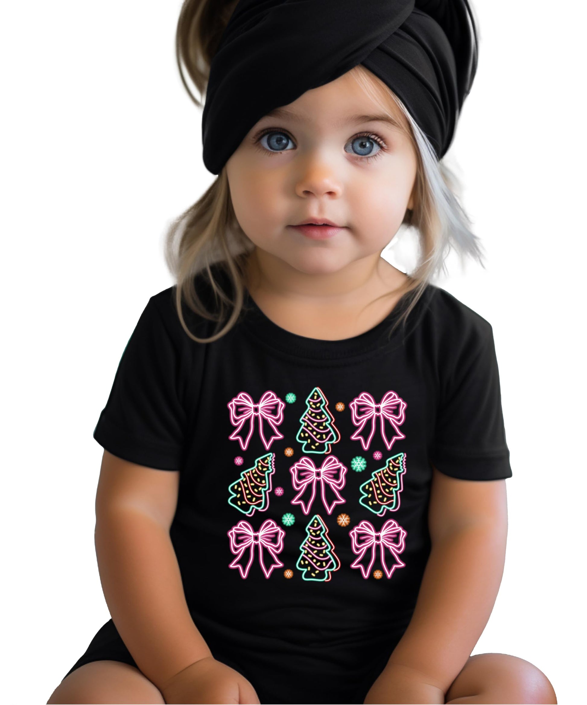 Close-up of vibrant neon holiday graphic with Christmas trees and bows on black women's tee