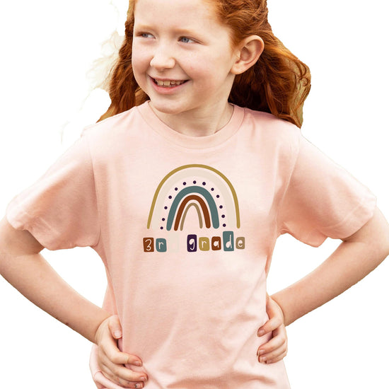 Detail shot of 3rd Grade First Day of School rainbow design on pink youth shirt