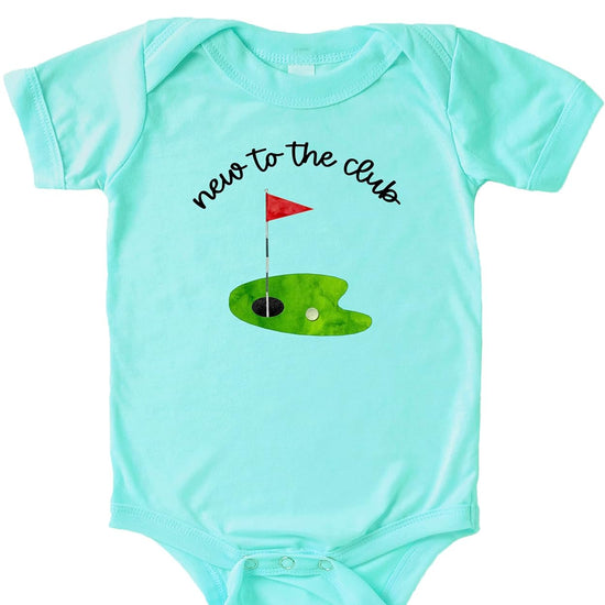 Close-up of New to the Club golf graphic with red pin flag and golf ball on natural bodysuit