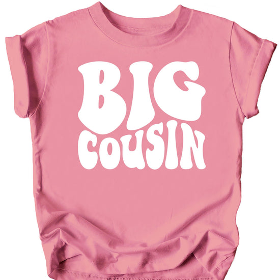 Close-up of white retro groovy Big Cousin print on military green kids shirt