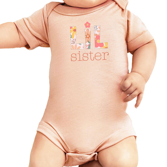 Peach baby bodysuit with floral 'Lil Sister' letter design for newborn girls