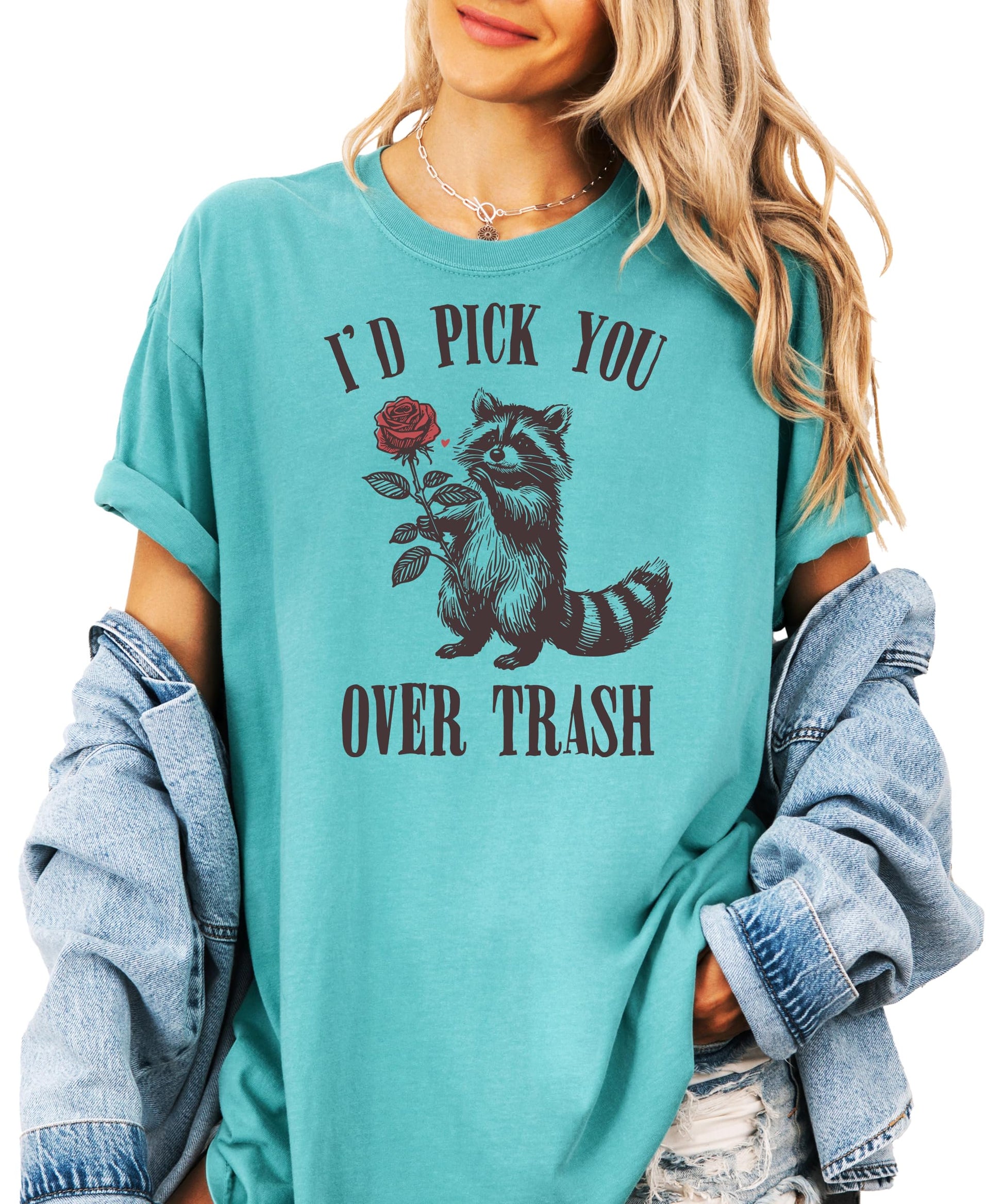 Women's ivory graphic tee with a raccoon holding a rose and text 'I'd Pick You Over Trash' — funny Valentine's Day shirt