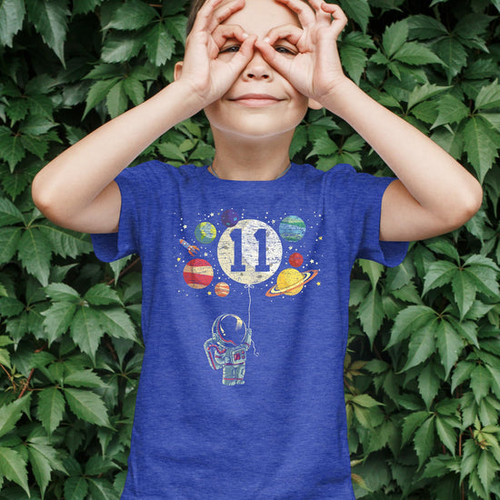 Flat lay of kids 11th birthday astronaut shirt showing full print detail