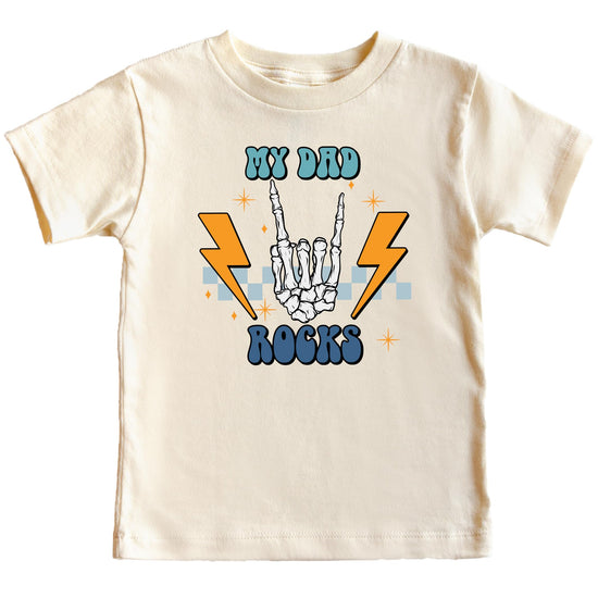 Young child wearing My Dad Rocks natural graphic tee with skeleton hand print