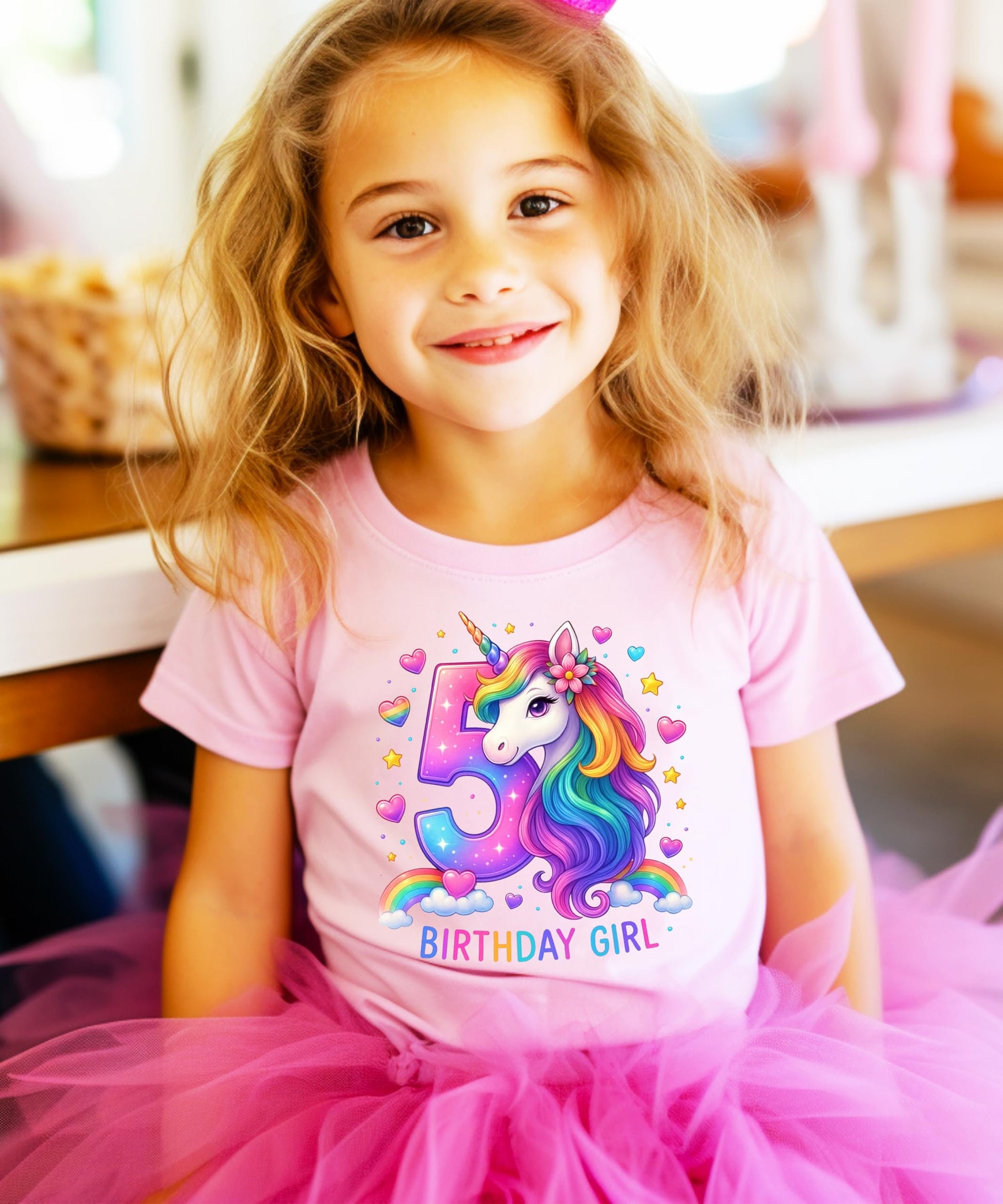 Young girl wearing pink 5th birthday unicorn graphic tee at party celebration