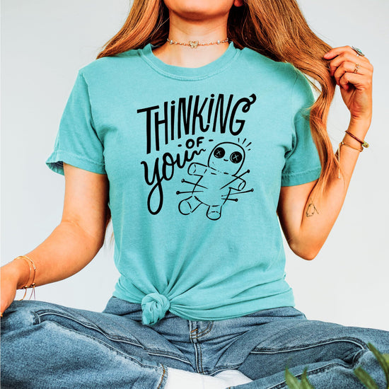 Flat lay of voodoo doll shirt showing full design and shirt silhouette