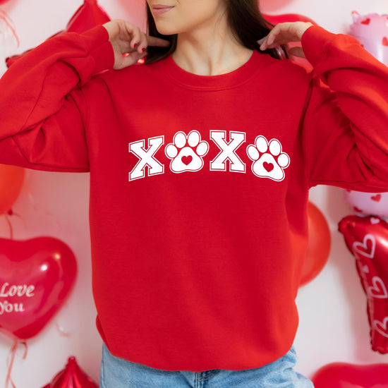 Close-up of XoXo pawprint graphic print on Valentine's Day sweatshirt