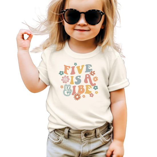 Girls' natural color tee with groovy retro 'Five is a Vibe' graphic featuring colorful flowers and peace sign