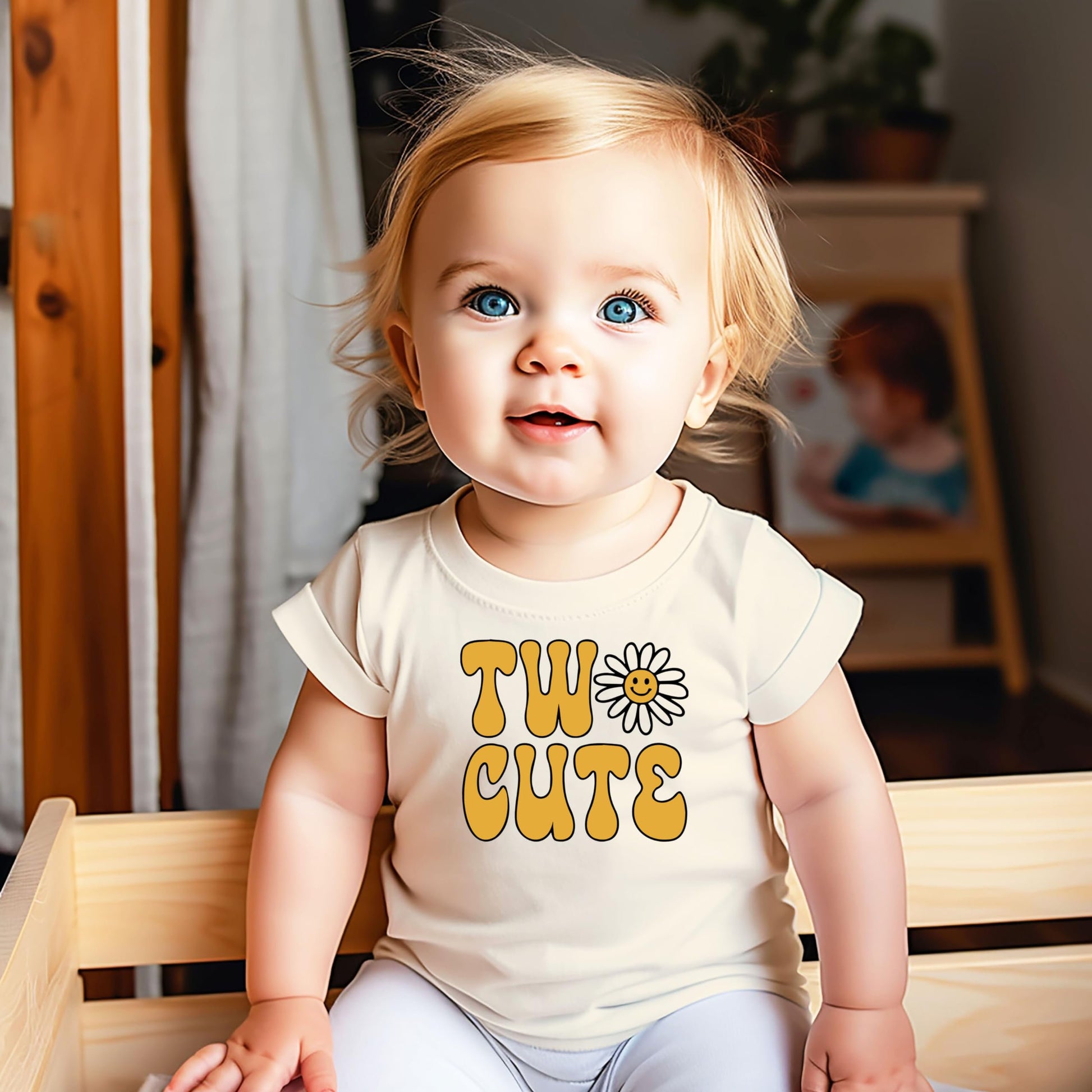 Close-up of Two Cute daisy print on natural birthday shirt for baby girls