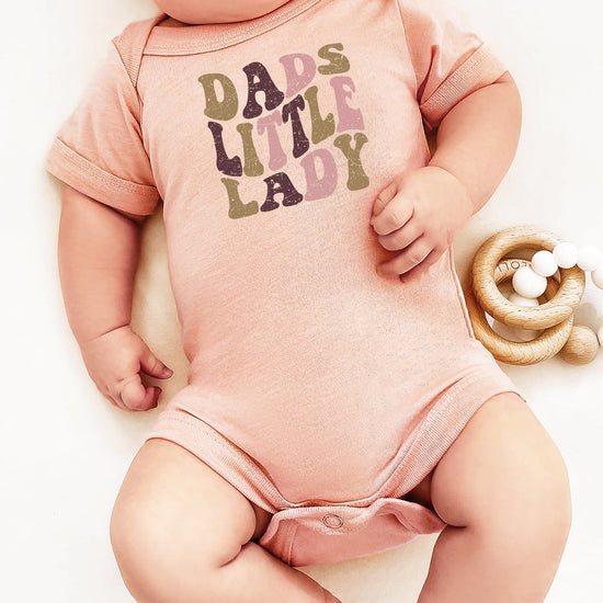 Dad's Little Lady newborn bodysuit displayed as a Father's Day or baby shower gift