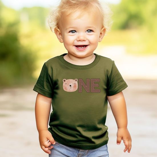 Detail shot of high-quality bear face ONE print on boys 1st birthday shirt