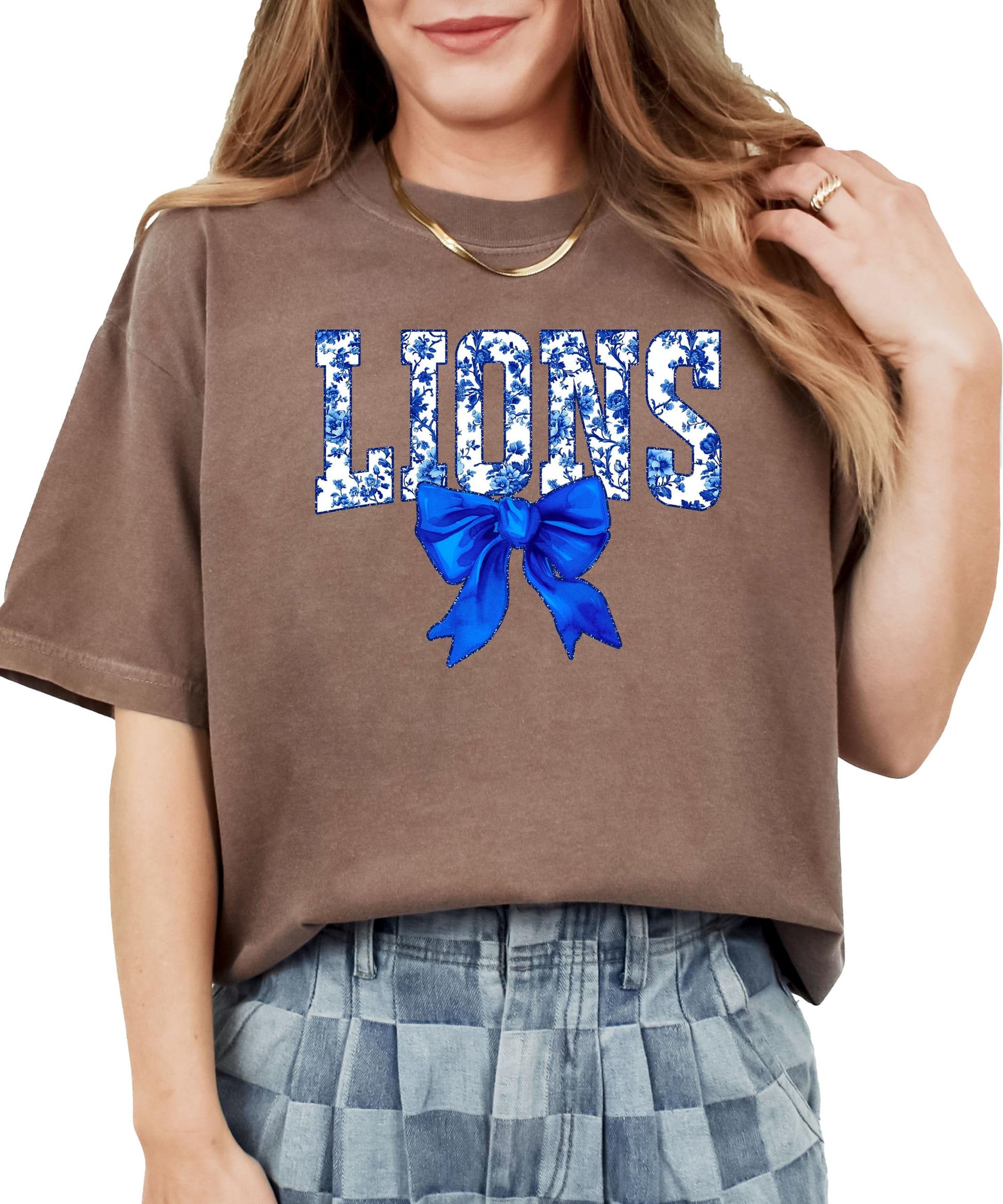 Flat lay of ivory Lions t-shirt displaying full floral bow design