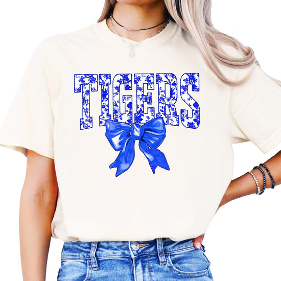 Front view of Tigers school spirit shirt with floral lettering and blue bow detail