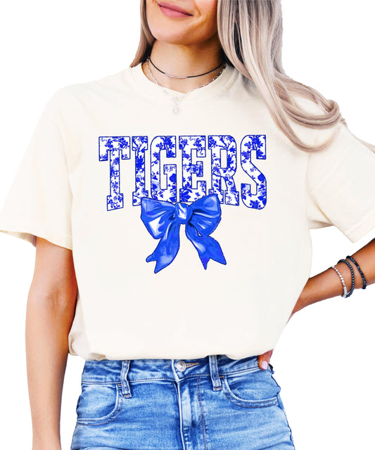Front view of Tigers school spirit shirt with floral lettering and blue bow detail