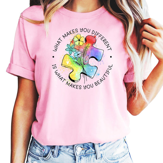 Pink autism awareness t-shirt with colorful watercolor puzzle pieces and What Makes You Different text